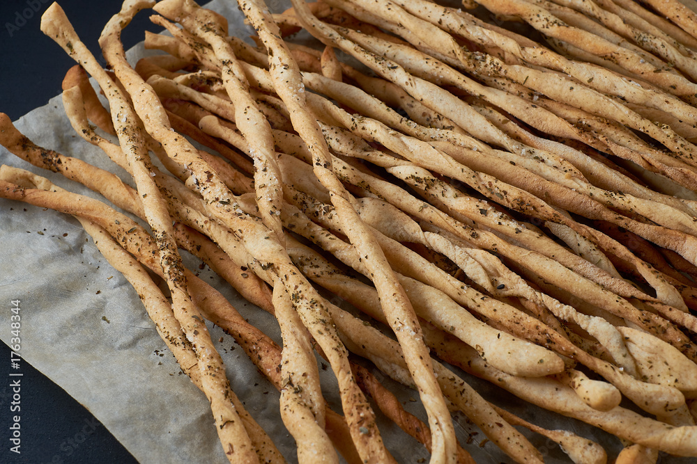 Traditional Italian snack, bread - grissini. On a dark stone table. Traditional Italian snack, bread - grissini. On a dark stone table.
