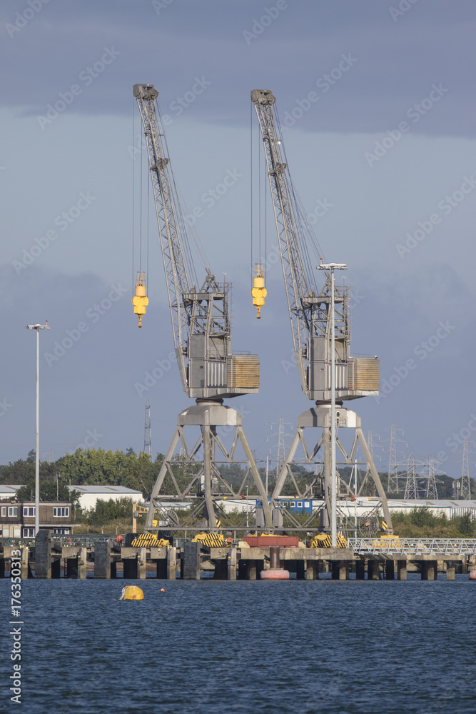 Fototapeta premium Two Dockside Cranes in Southampton against a blue sky