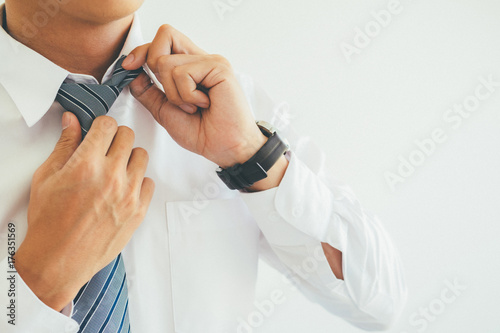 Fashion the hands of a young businessman handsome model man on his business suit close up