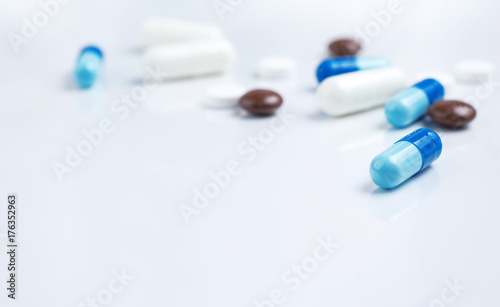Pharmaceutical medical colorful pills and capsules on white background