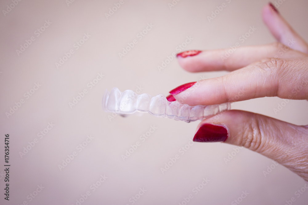 Invisible dental orthodontics held by a woman Invisible dental orthodontics held by a woman