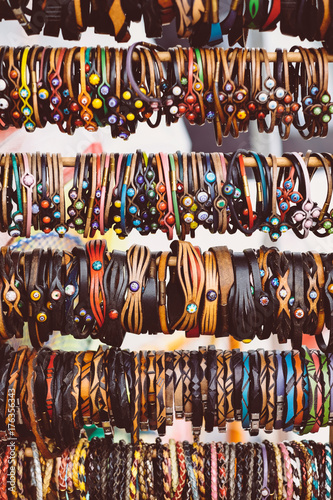 Native handcrafts colorful bracelets in market © Ivan Trizlic