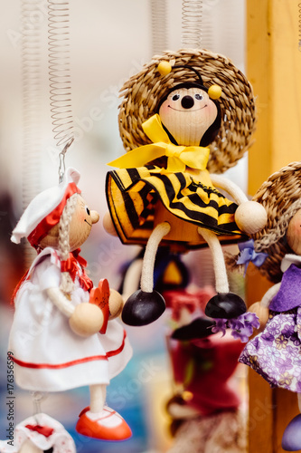 Wooden dolls dressed in diffirent outfits. handmade wooden dolls hanging as a display. decirative dolls photo