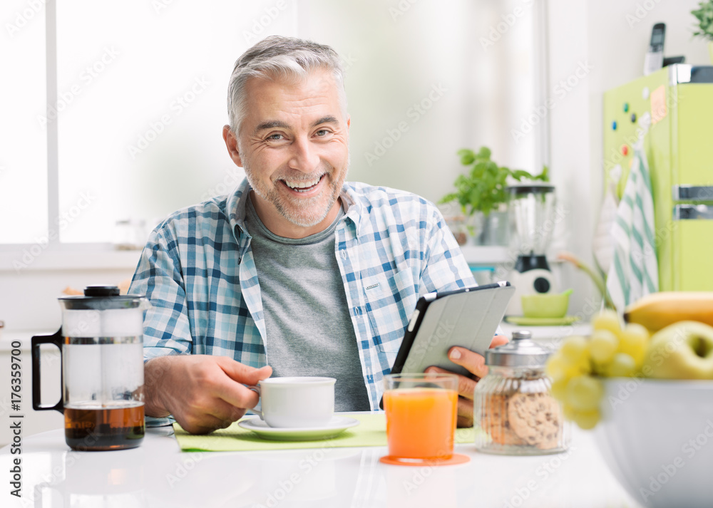 Man having breakfast and social networking Man having breakfast and social networking