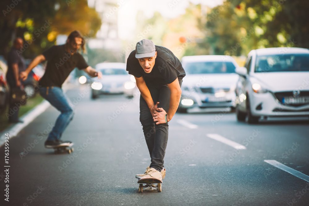 Two pro skateboard rider ride skate through cars on street Two pro skateboard rider ride skate through cars on street