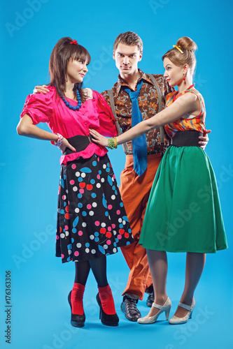 Love triangle. Young people wearing colorful old-fashion clothes in pinup style photo