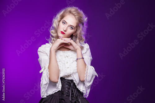 Beautiful, tender, blond woman in a white old blouse. On a purple background. A girl in the shape of a doll. Lolita. Victorian blouse