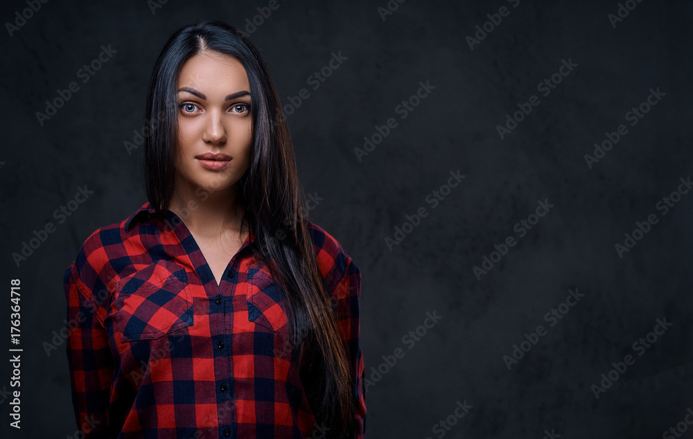 A woman dressed in a red fleece shirt over grey background.