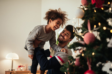 Reaching for the top of the Christmas tree!
