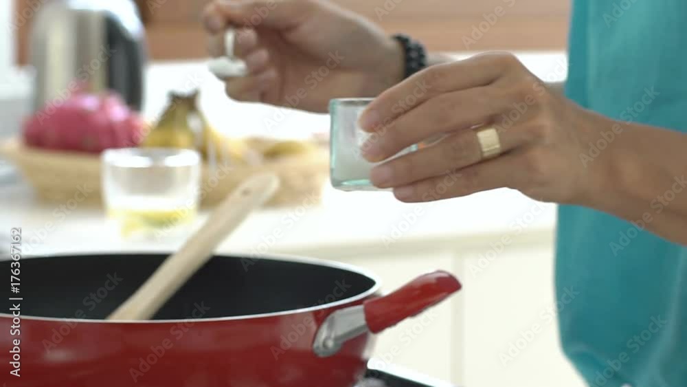Woman mixing ingredients on frying pan and adding salt, steadycam shot
Woman mixing ingredients on frying pan and adding salt, steadycam shot