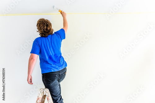 Fototapeta Naklejka Na Ścianę i Meble -  Man painting wall, home renovation and working indoors concept
