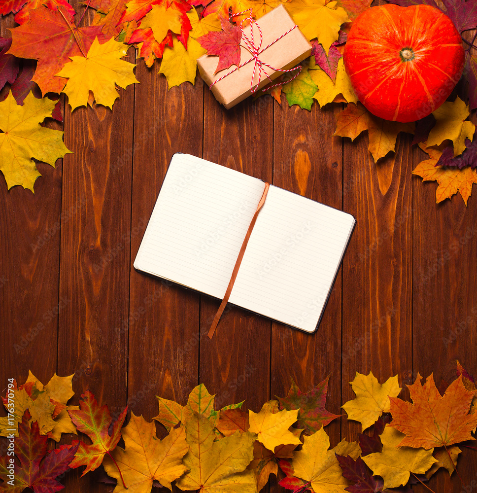 border frame of colorful autumn leaves on wooden background with gift ...