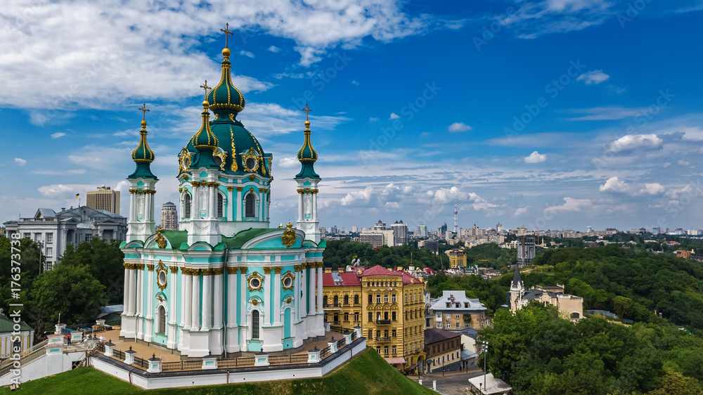 Aerial top view of Saint Andrew's church and Andreevska street from above, cityscape of Podol district, city of Kiev (Kyiv), Ukraine
