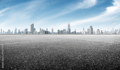 empty asphalt road with cityscape of shanghai in blue sky photo