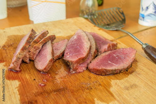 Medium rare angus beef steak cutted on wooden board.