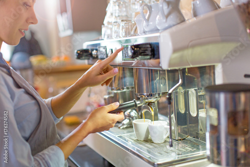 Fotografering Female barista making coffee