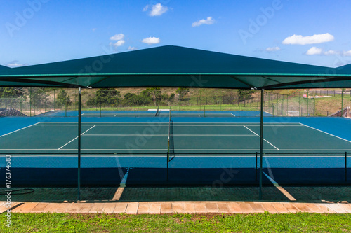 Tennis Courts hard surface with shade Awnings outdoors .