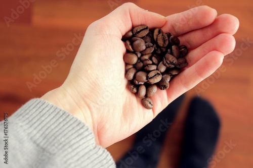Woman hands holding coffee beans