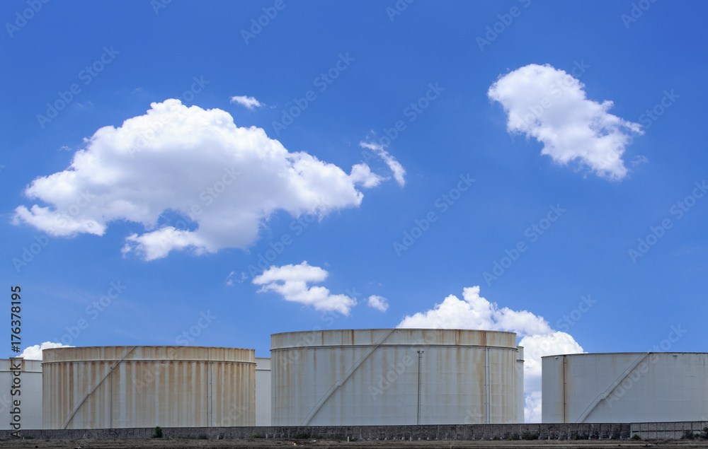 oil storage tanks with blue sky and clouds oil storage tanks with blue sky and clouds