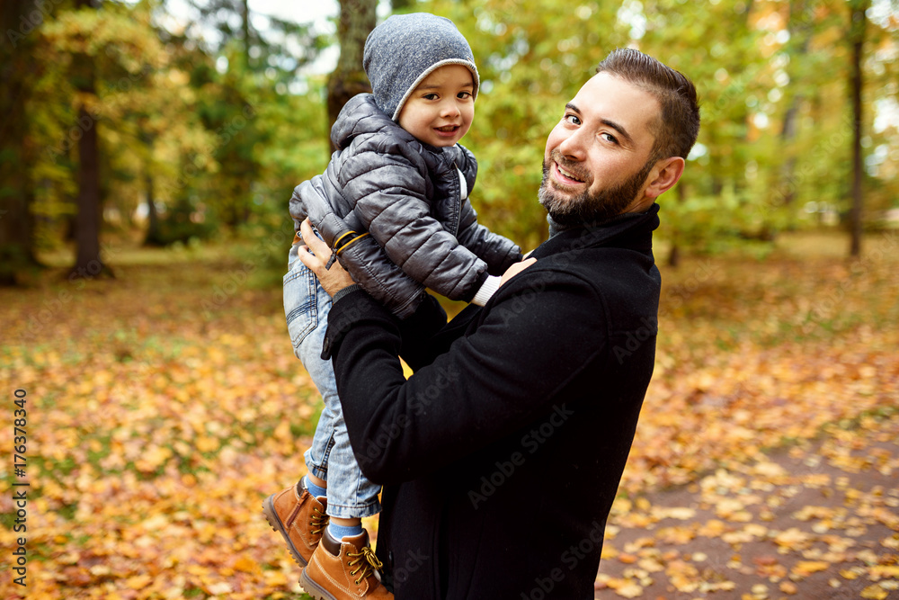 father with son in autumn park father with son in autumn park
