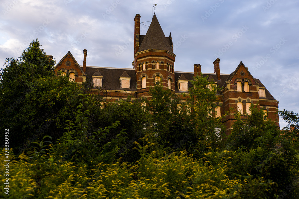 Main Building at Sunset Surrounded by Yellow Goldenrods - Abandoned Hudson River State Hospital - New York