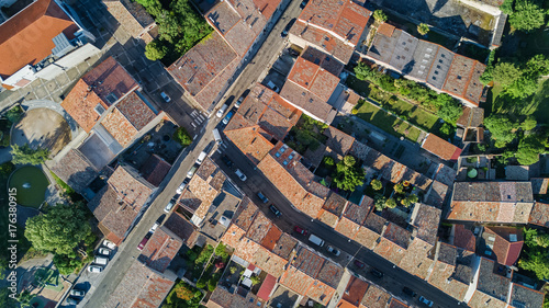 Aerial top view of residential area houses roofs and streets from above, old medieval town background 