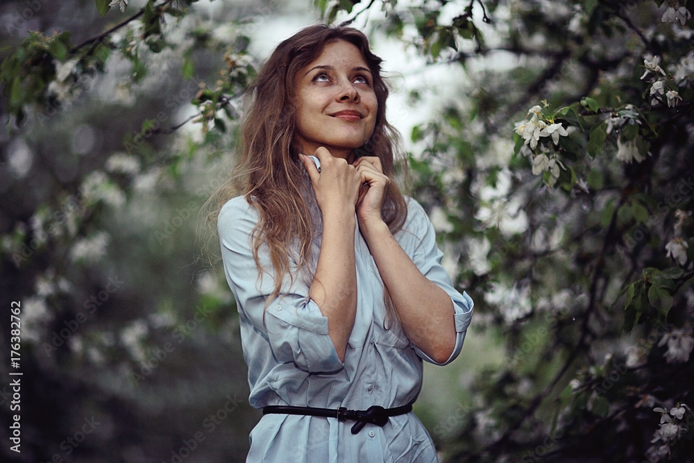 young adult girl enjoys smell of spring flowers apple young adult girl enjoys smell of spring flowers apple