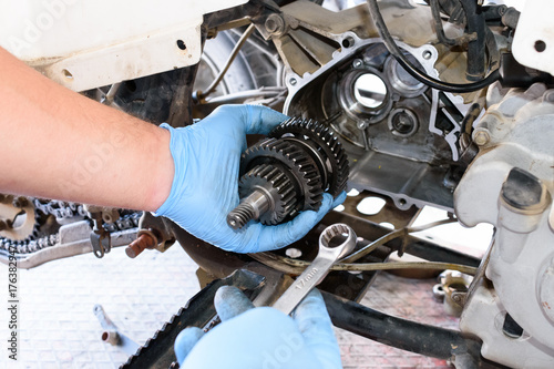 Hand with tools, Professional mechanic repair and modifications to ATV photo