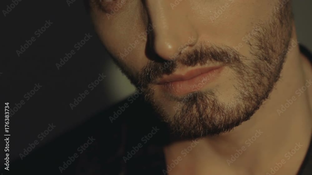 Sensual passionate look at camera of handsome man on background