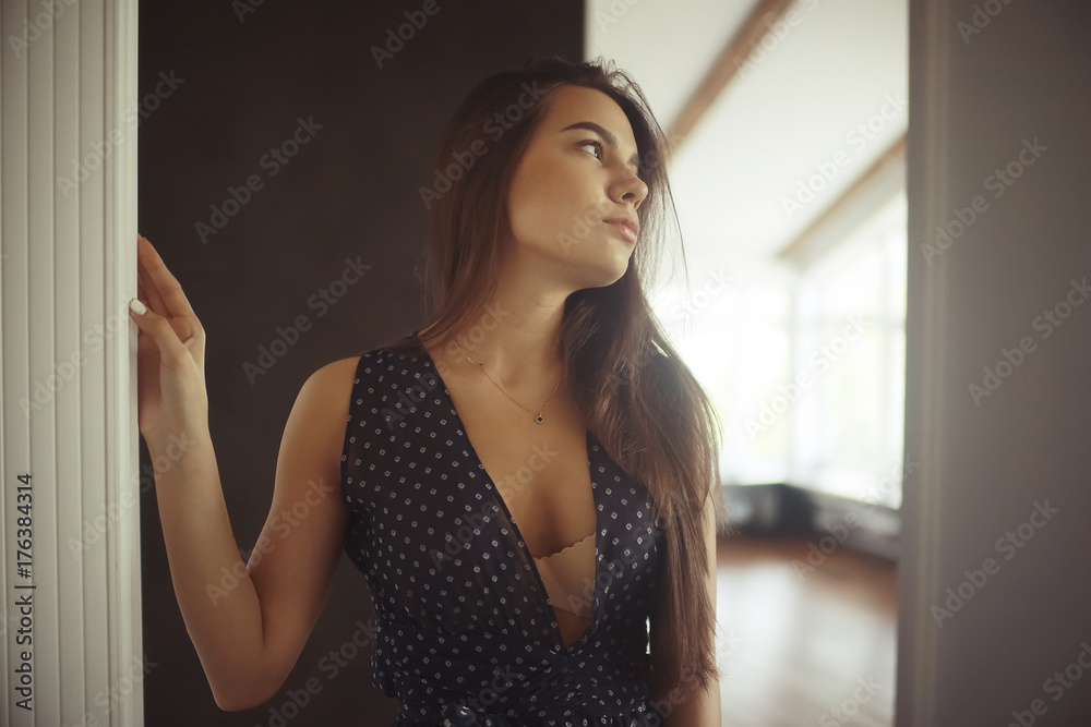 Young romantic girl by the window Young romantic girl by the window