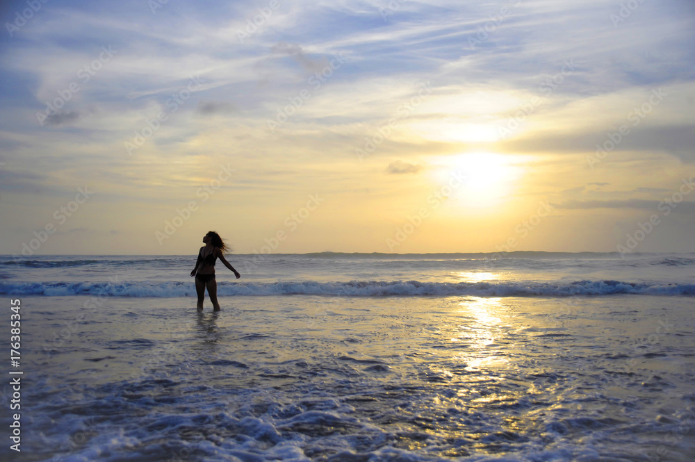 young active woman on sea landscape sunset horizon with amazing sun and dramatic orange sky