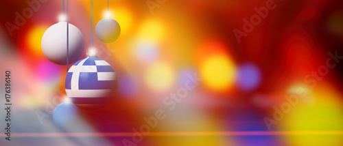 Greece flag on Christmas ball with blurred and abstract background.