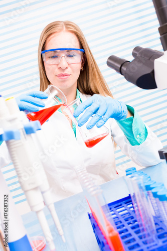 A female lab assistant doing scientific experiments in a scientific laboratory