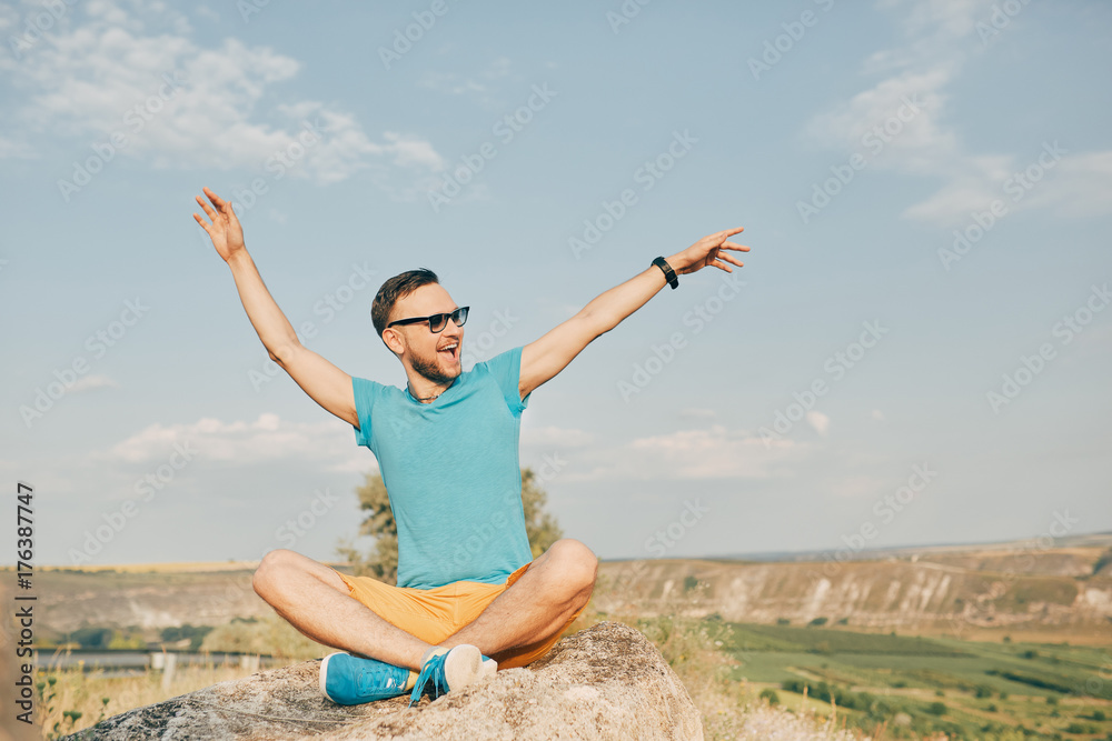 Young man smiling and enjoying sunny summer day Young man smiling and enjoying sunny summer day