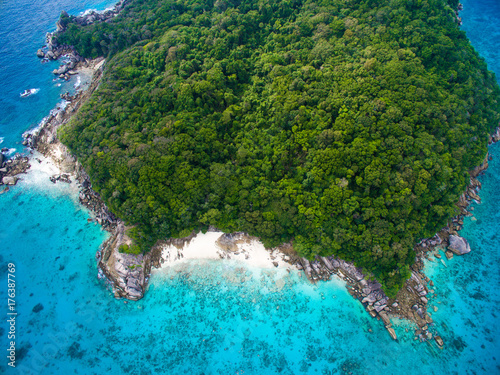 Top aerial view of isolated beautiful tropical island with white sand beach, blue clear water and granite stones. Also top view of speedboats above coral reef. Similan Islands, Thailand. © Marina