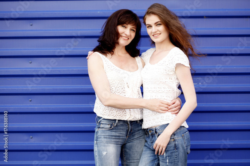 Portrait of happy senior mother and grown-up daughter hugging showing love and care