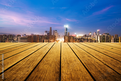 empty wooden floor with cityscape of hangzhou at twilight