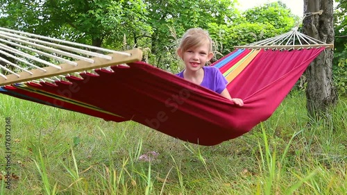 the child is resting on the hammock