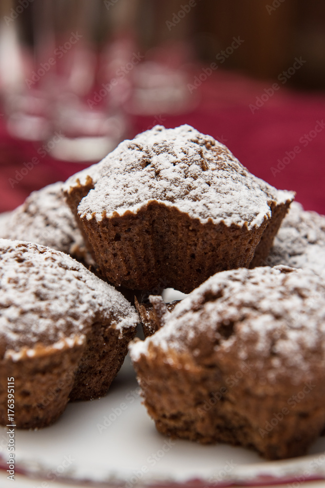 cake with raisins at the plate, sprinkled with powdered sugar cake with raisins at the plate, sprinkled with powdered sugar