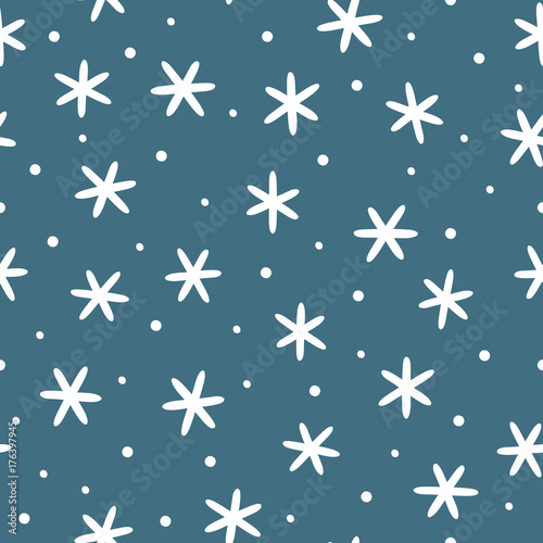 Winter seamless pattern. White snowflakes on blue background.