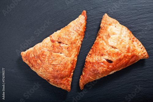 Food concept Fresh bake Homemade meal beefs or chicken triangle puff pie on slate stone with copy space