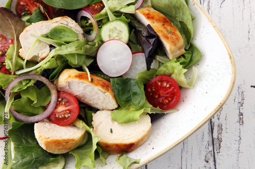 Chicken salad with leaf vegetables and cherry tomatoes.