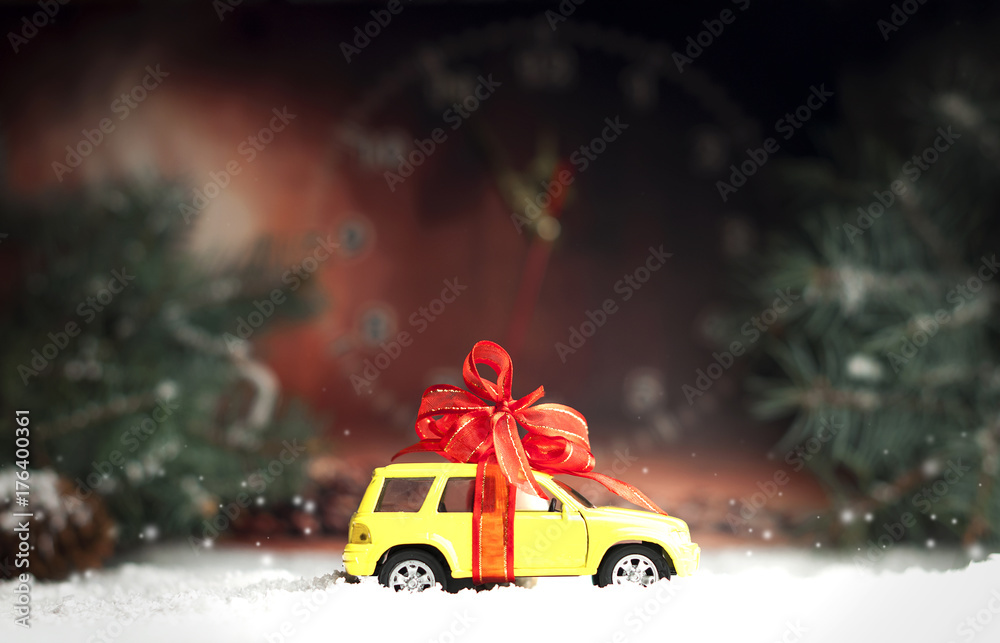 small car with a decorative bow in snow