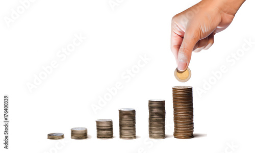 Saving money. Female hand stack coins to shown concept of growing business and wealthy