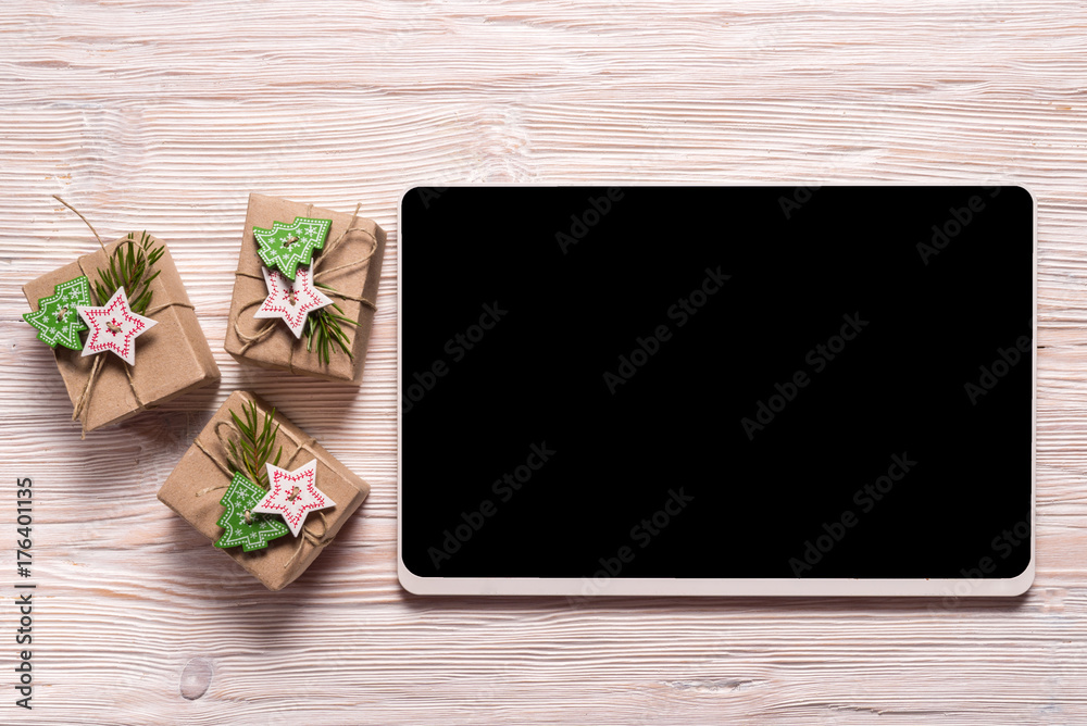 Gift box and digital tablet on wooden bakcground Gift box and digital tablet on wooden bakcground