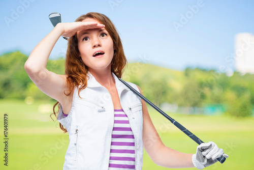 Watching the flight of a golf ball on a background of golf courses