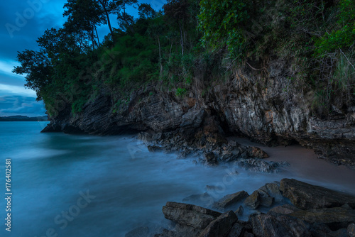 A gloomy seascape - the shore  rocks and running water