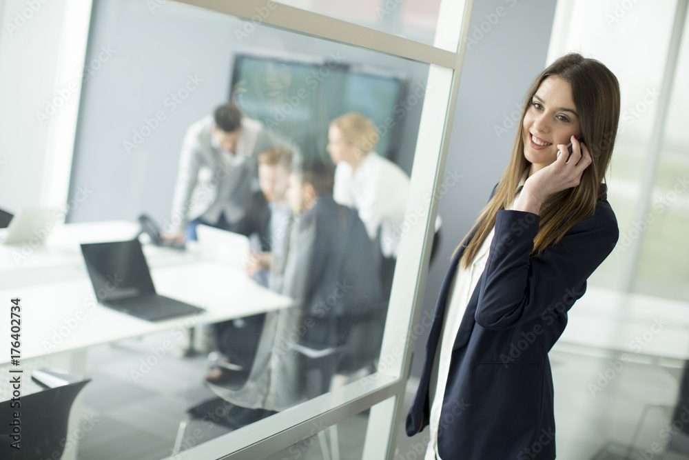 Image of agent with paper speaking on the phone in working environment
