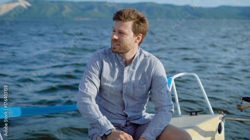 Pensive man on yacht sitting and enjoying views of sea © kustvideo