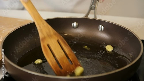 Frying crushed garlic flavoring hot olive oil photo